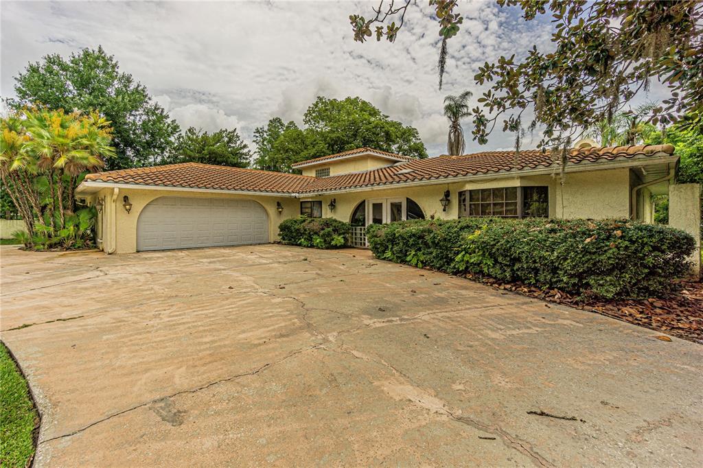 18129 Crawley Road Odessa, FL 33556 - Photo 4 of 38 a house with trees in the background