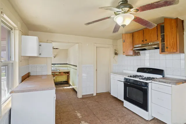 a kitchen with stainless steel appliances a stove a sink and a refrigerator