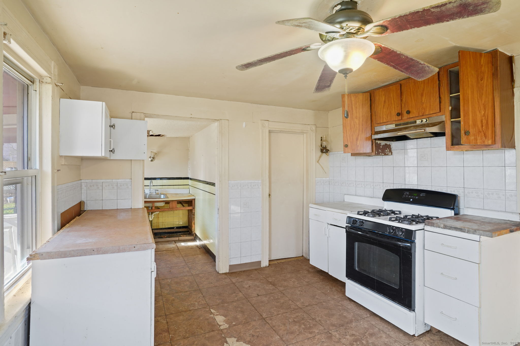 73 Carlson Avenue Bridgeport, CT 06606 - Photo 4 of 29 a kitchen with stainless steel appliances a stove a sink and a refrigerator