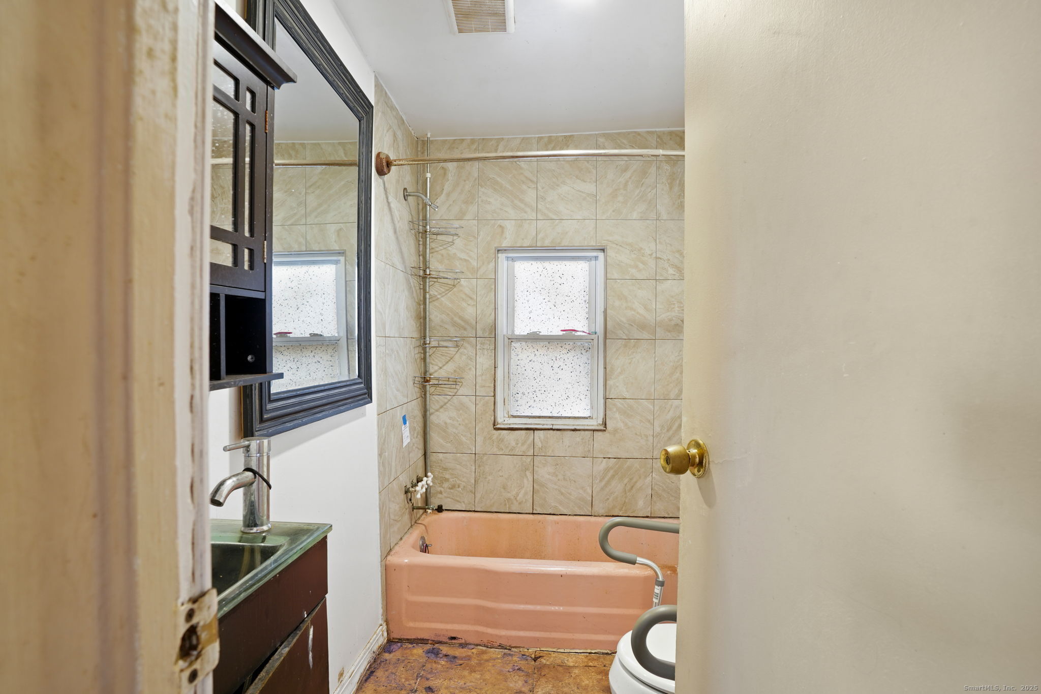 73 Carlson Avenue Bridgeport, CT 06606 - Photo 8 of 29 a bathroom with a granite countertop bathtub shower and a sink