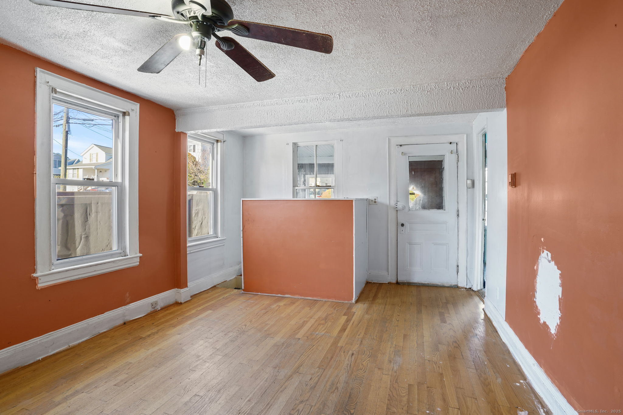 73 Carlson Avenue Bridgeport, CT 06606 - Photo 9 of 29 a view of empty room with wooden floor and fan