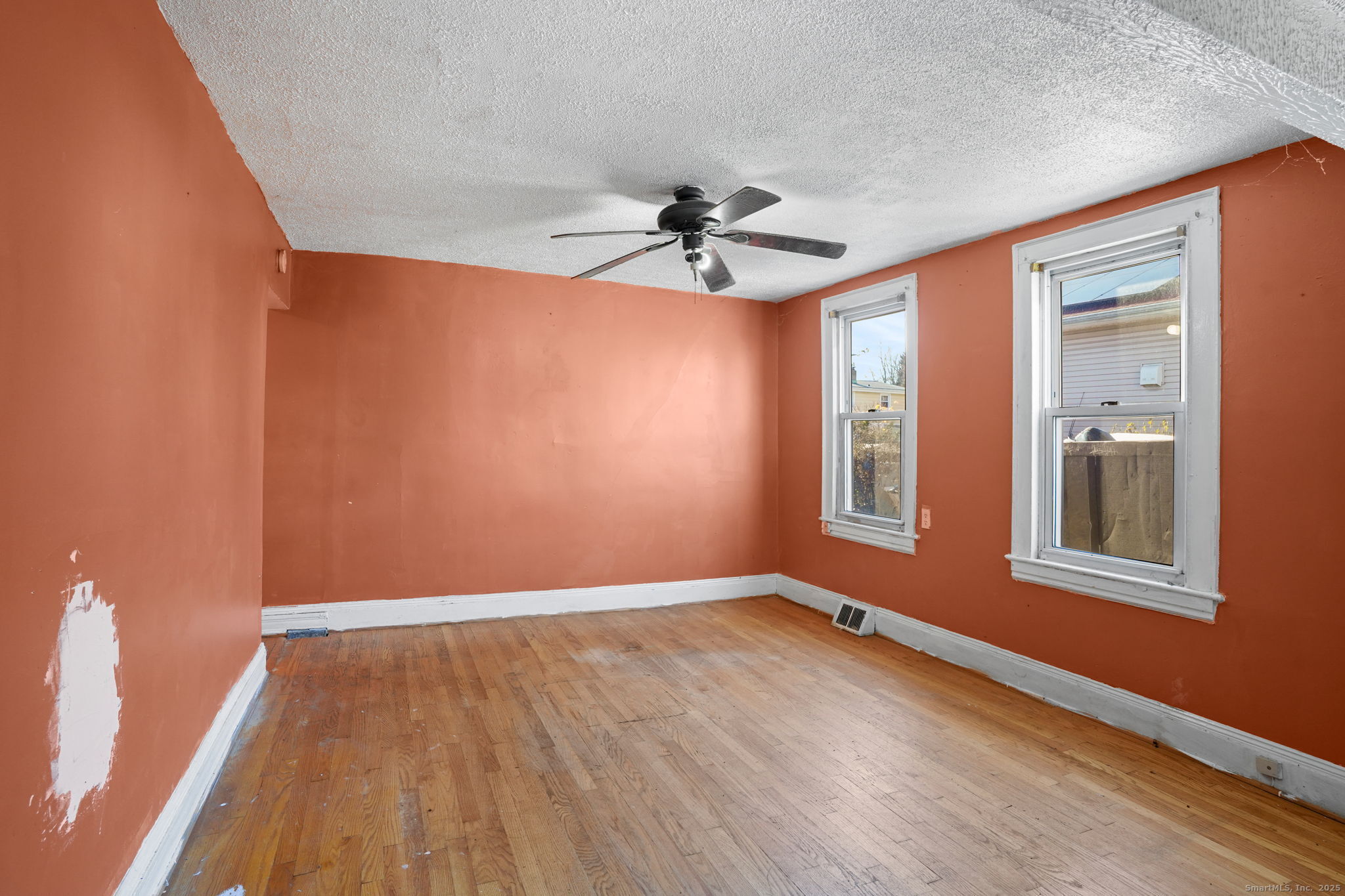 73 Carlson Avenue Bridgeport, CT 06606 - Photo 10 of 29 an empty room with windows and fan