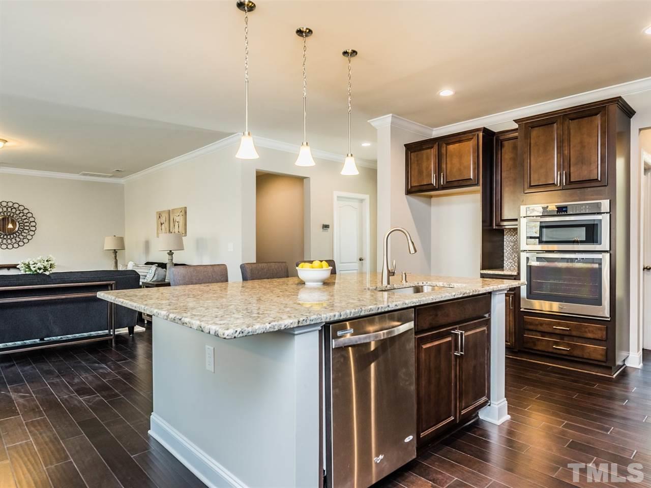 1809 Capstone Drive Durham, NC 27713 - Photo 11 of 25 a kitchen with stainless steel appliances granite countertop a sink a stove and a wooden floors
