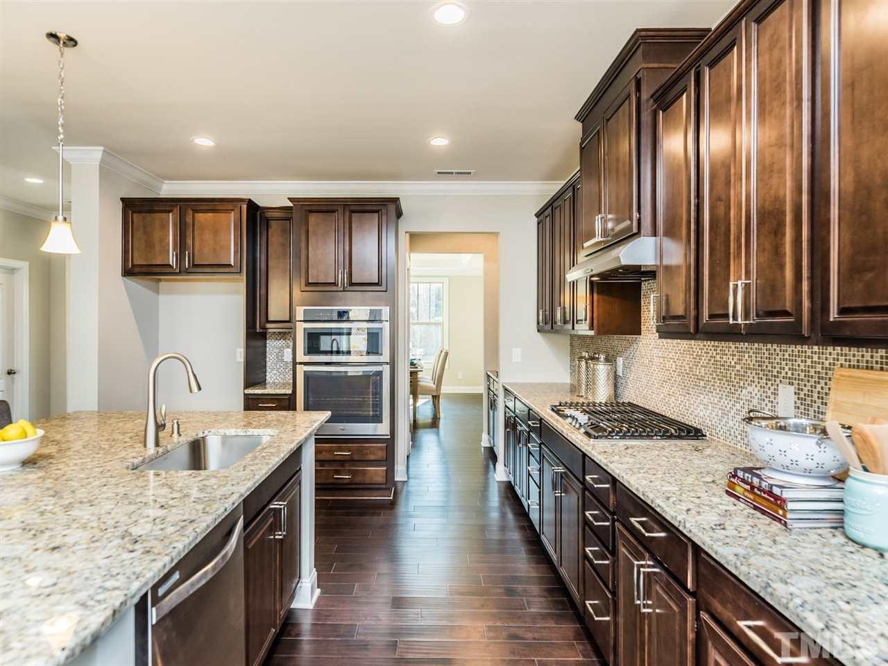 1809 Capstone Drive Durham, NC 27713 - Photo 13 of 25 a kitchen with stainless steel appliances granite countertop a sink stove and refrigerator