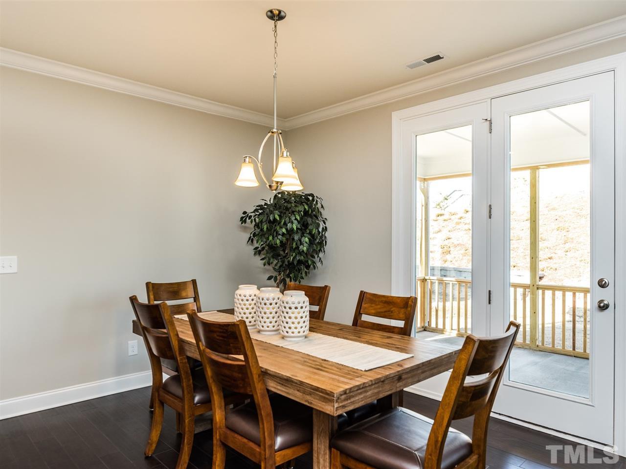 1809 Capstone Drive Durham, NC 27713 - Photo 14 of 25 a view of a dining room with furniture window and chandelier