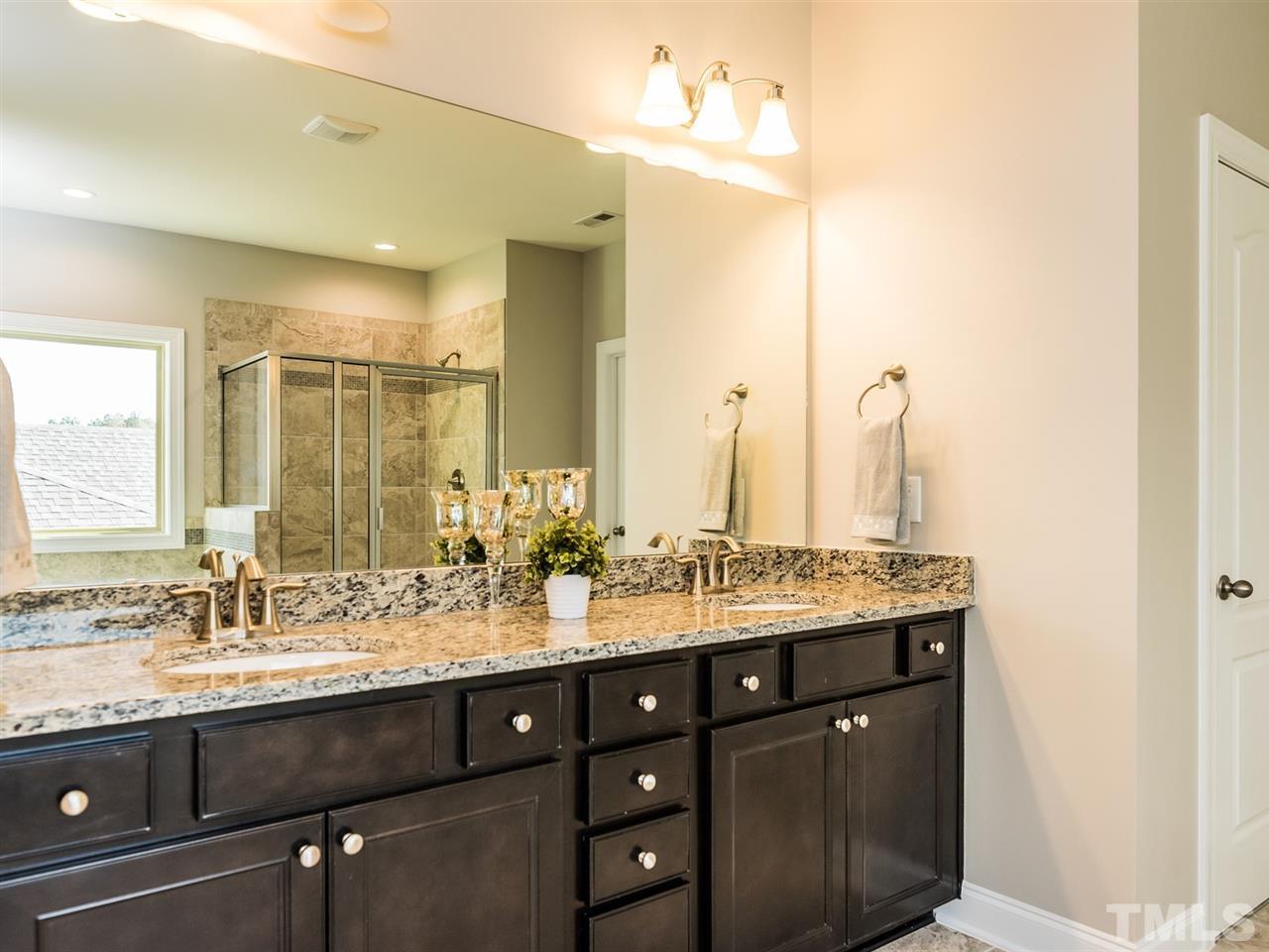 1809 Capstone Drive Durham, NC 27713 - Photo 19 of 25 a bathroom with a double vanity sink and a mirror