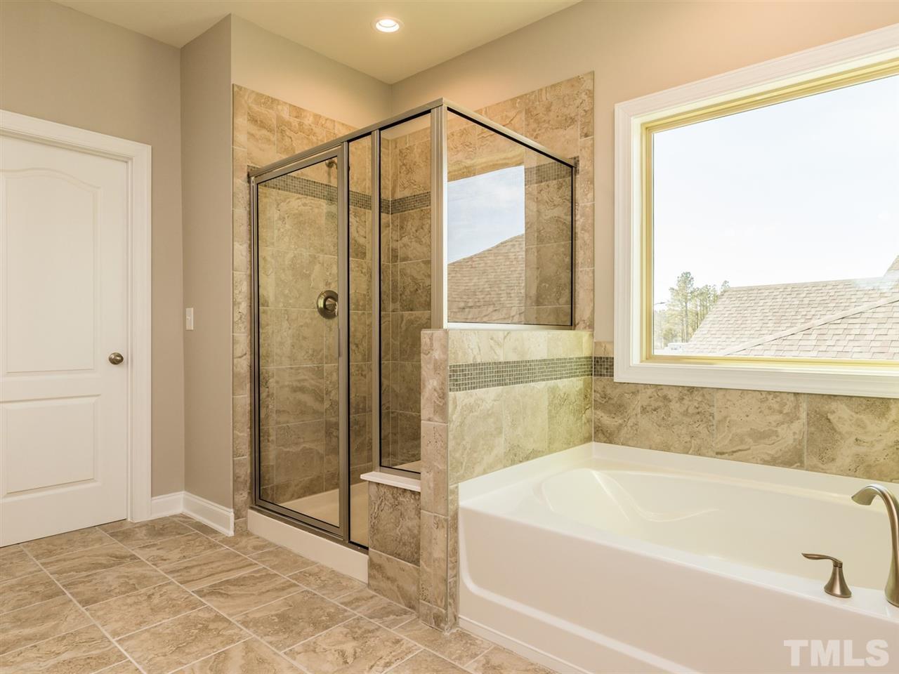 1809 Capstone Drive Durham, NC 27713 - Photo 20 of 25 a bathroom with a bathtub and a shower
