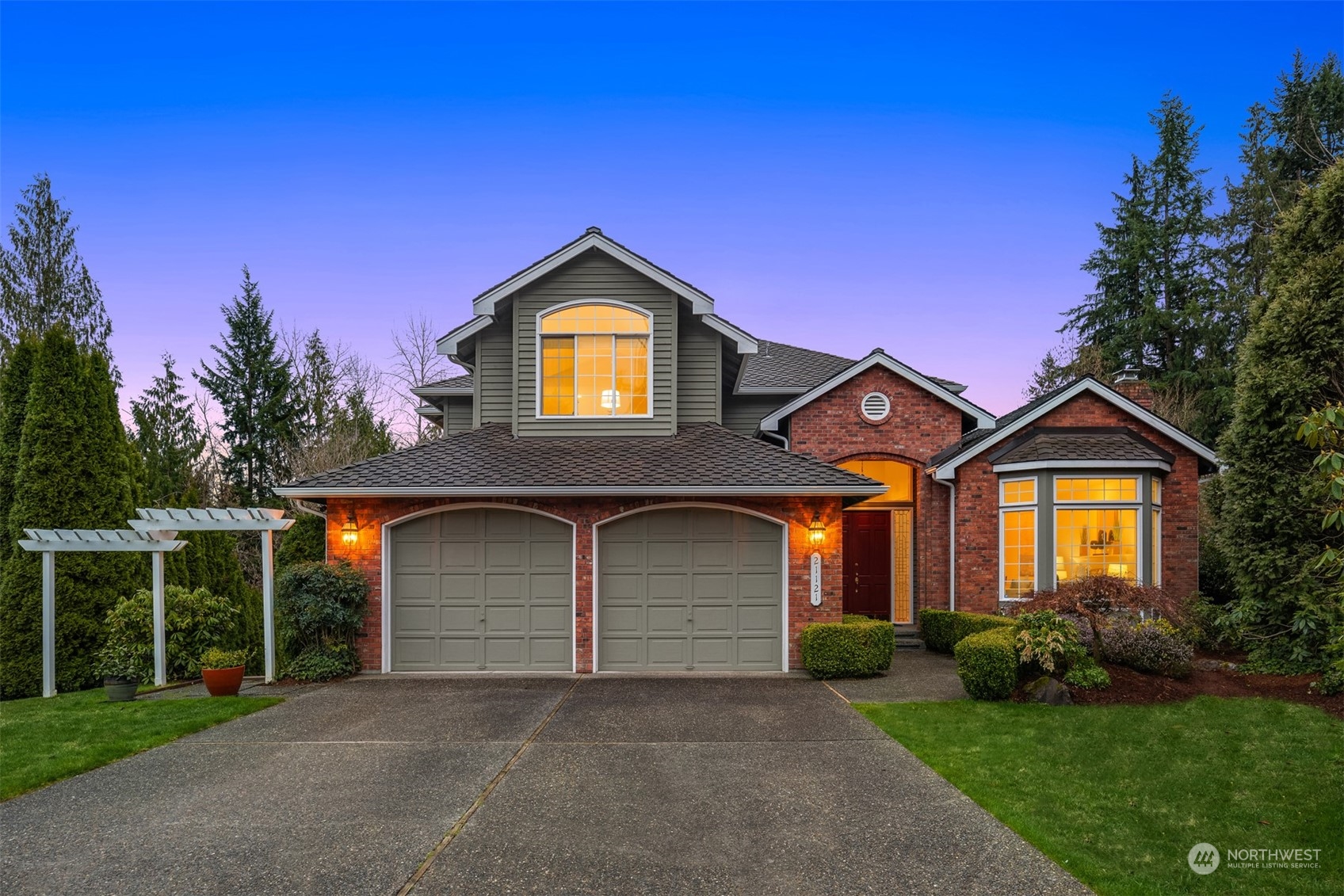 a front view of a house with a yard and garage