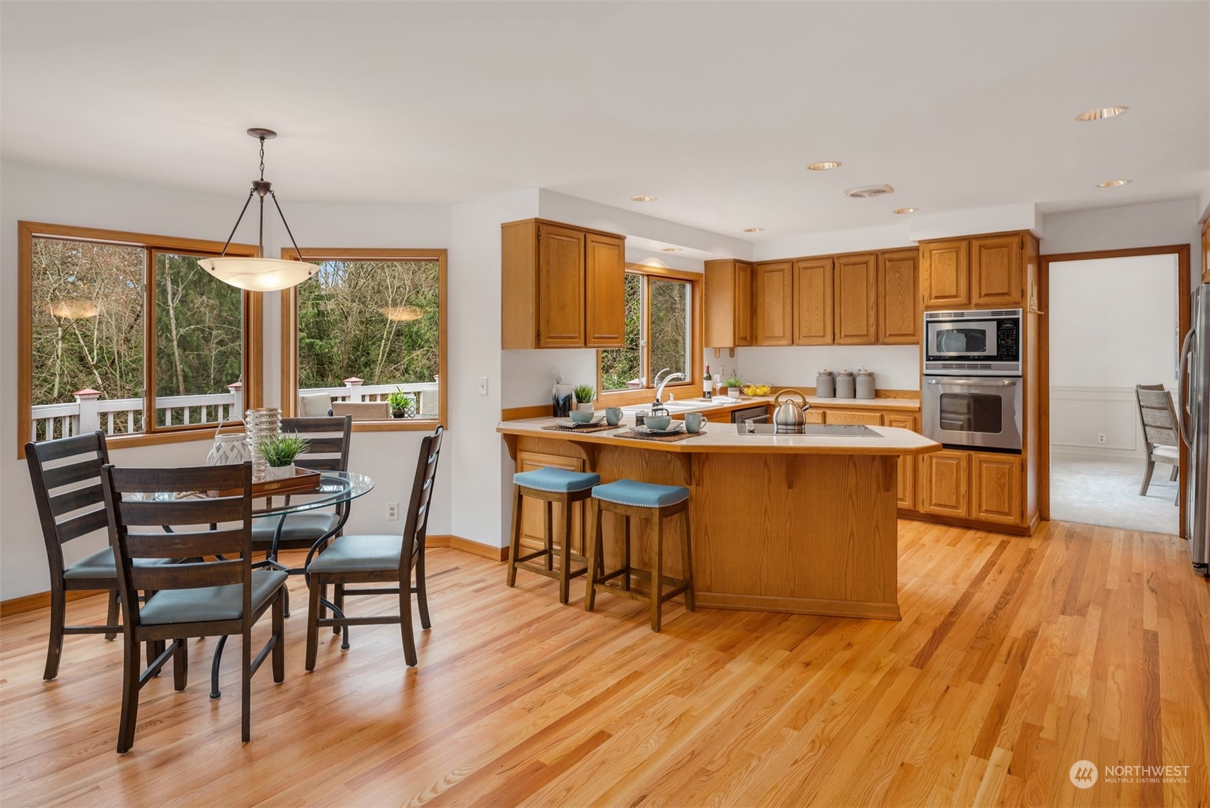 21121 50th Drive Southeast Bothell, WA 98021 - Photo 9 of 38 a room with stainless steel appliances kitchen island granite countertop wooden floor a dining table and chairs