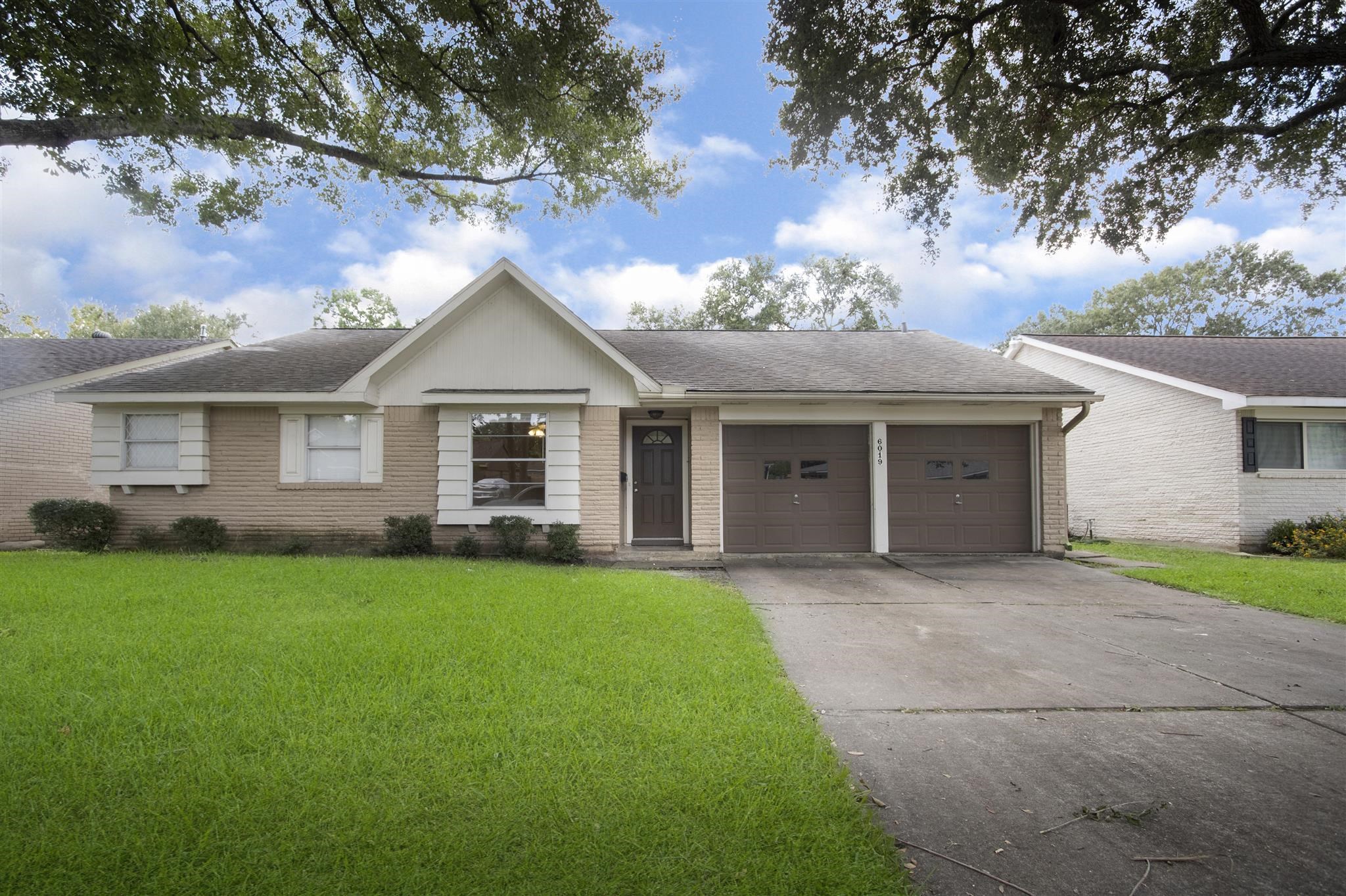 6019 Spellman Road Houston, TX 77096 - Photo 1 of 19 front view of a house and a yard