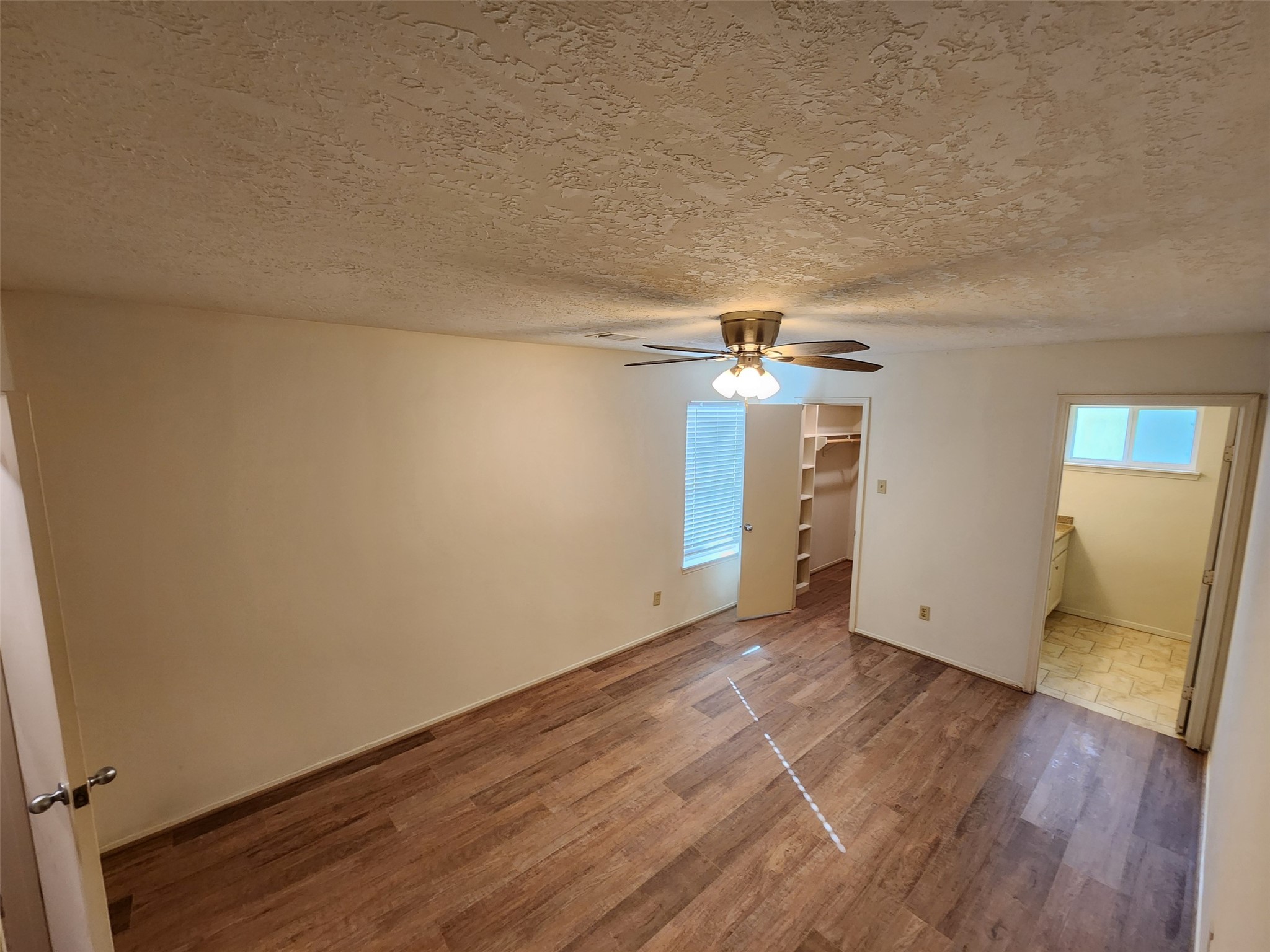 6019 Spellman Road Houston, TX 77096 - Photo 14 of 19 an empty room with wooden floor and natural light