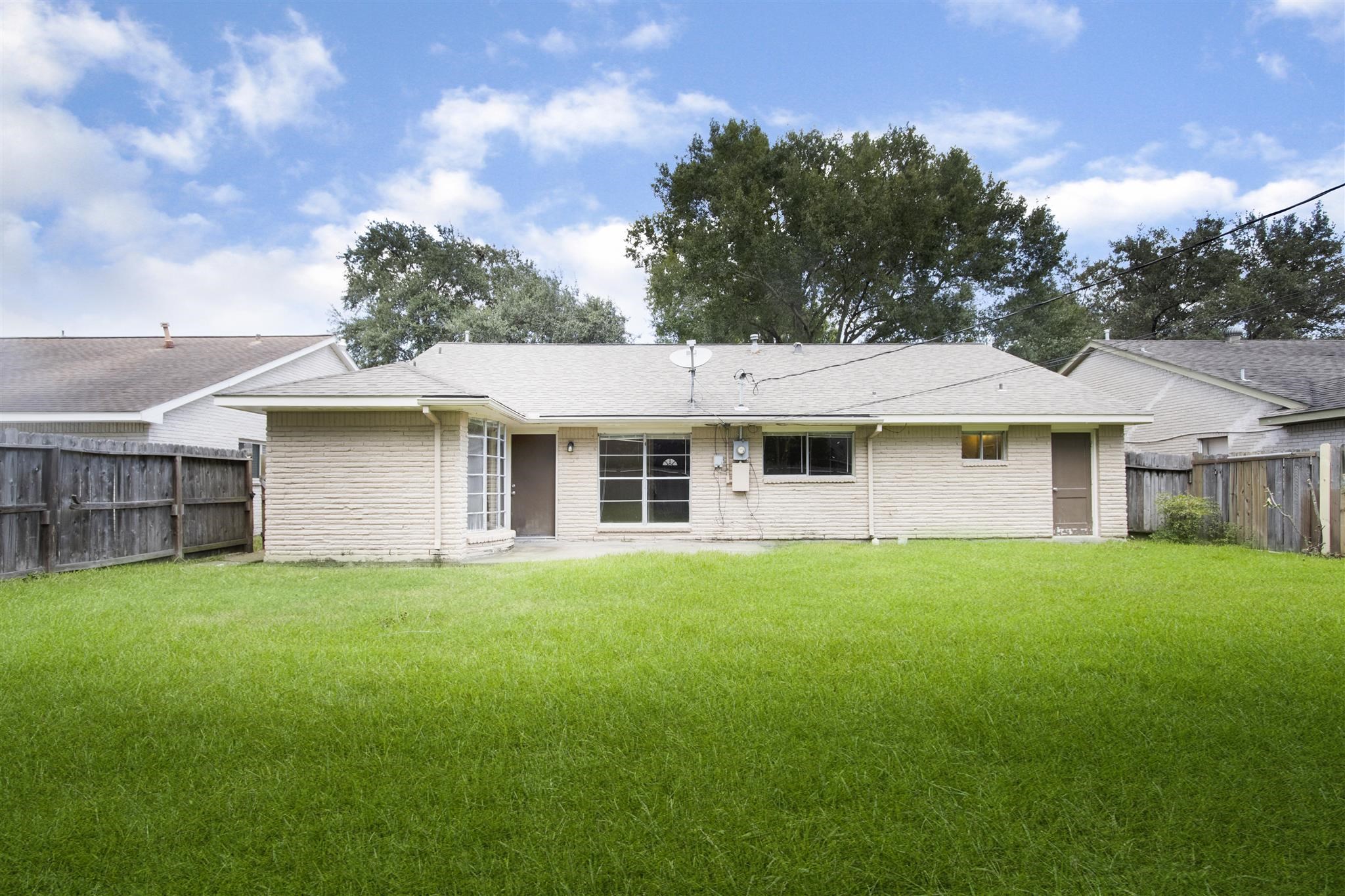 6019 Spellman Road Houston, TX 77096 - Photo 17 of 19 a front view of a house with a garden