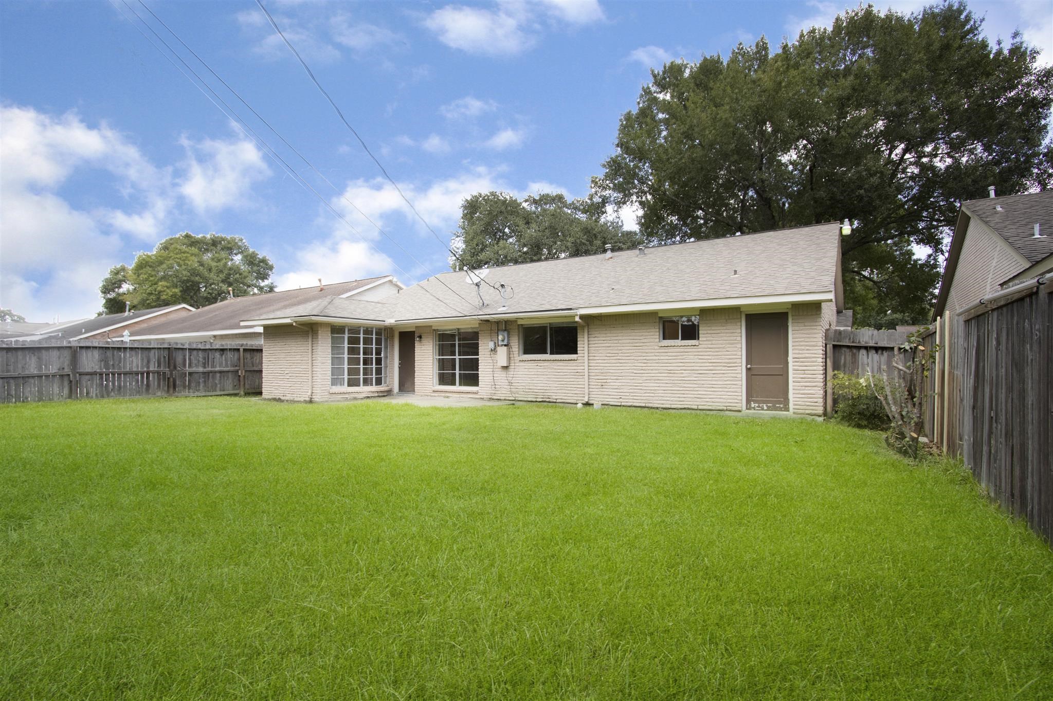 6019 Spellman Road Houston, TX 77096 - Photo 19 of 19 a view of a yard in front of a house with a large tree