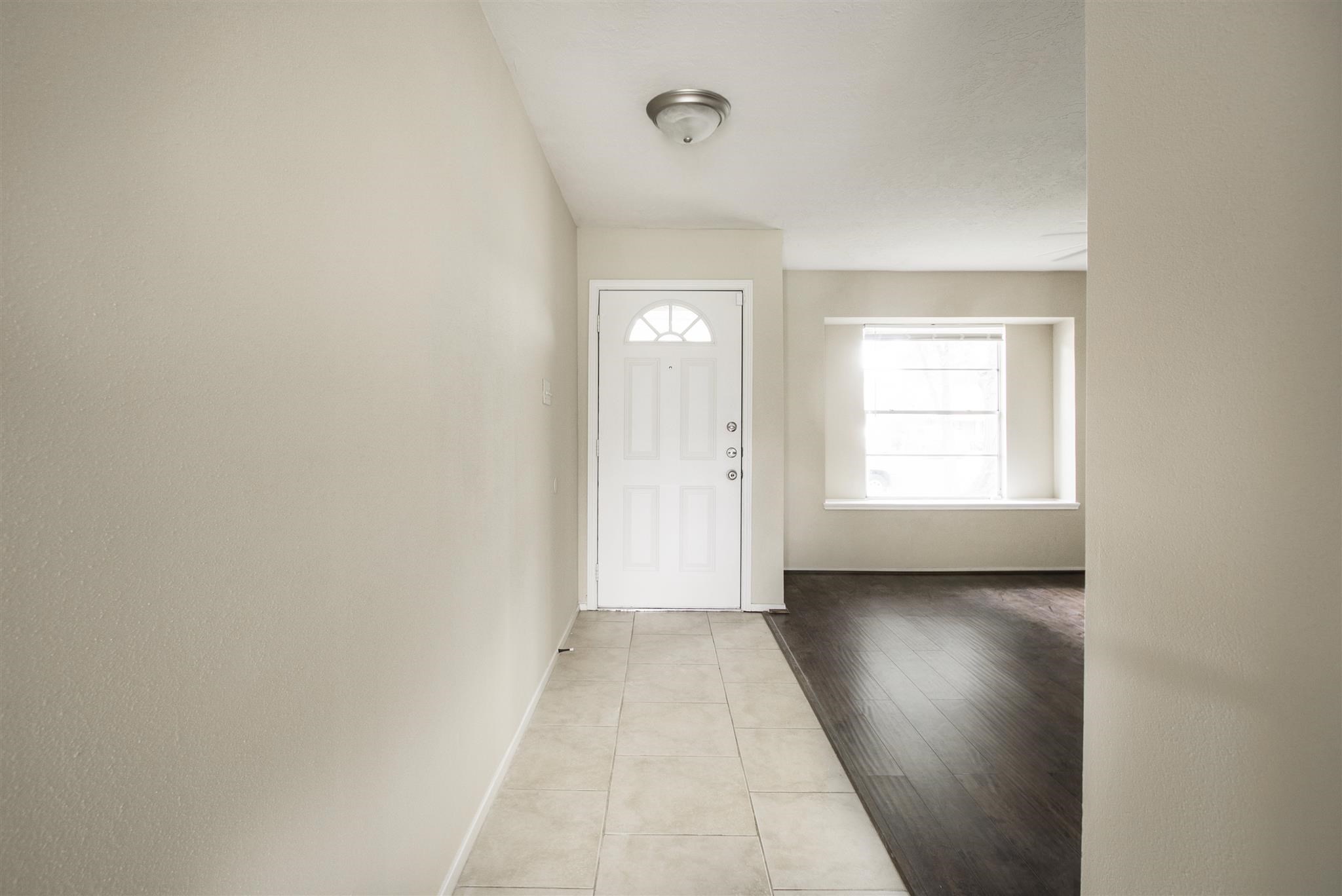 6019 Spellman Road Houston, TX 77096 - Photo 4 of 19 a view of an empty room with a window