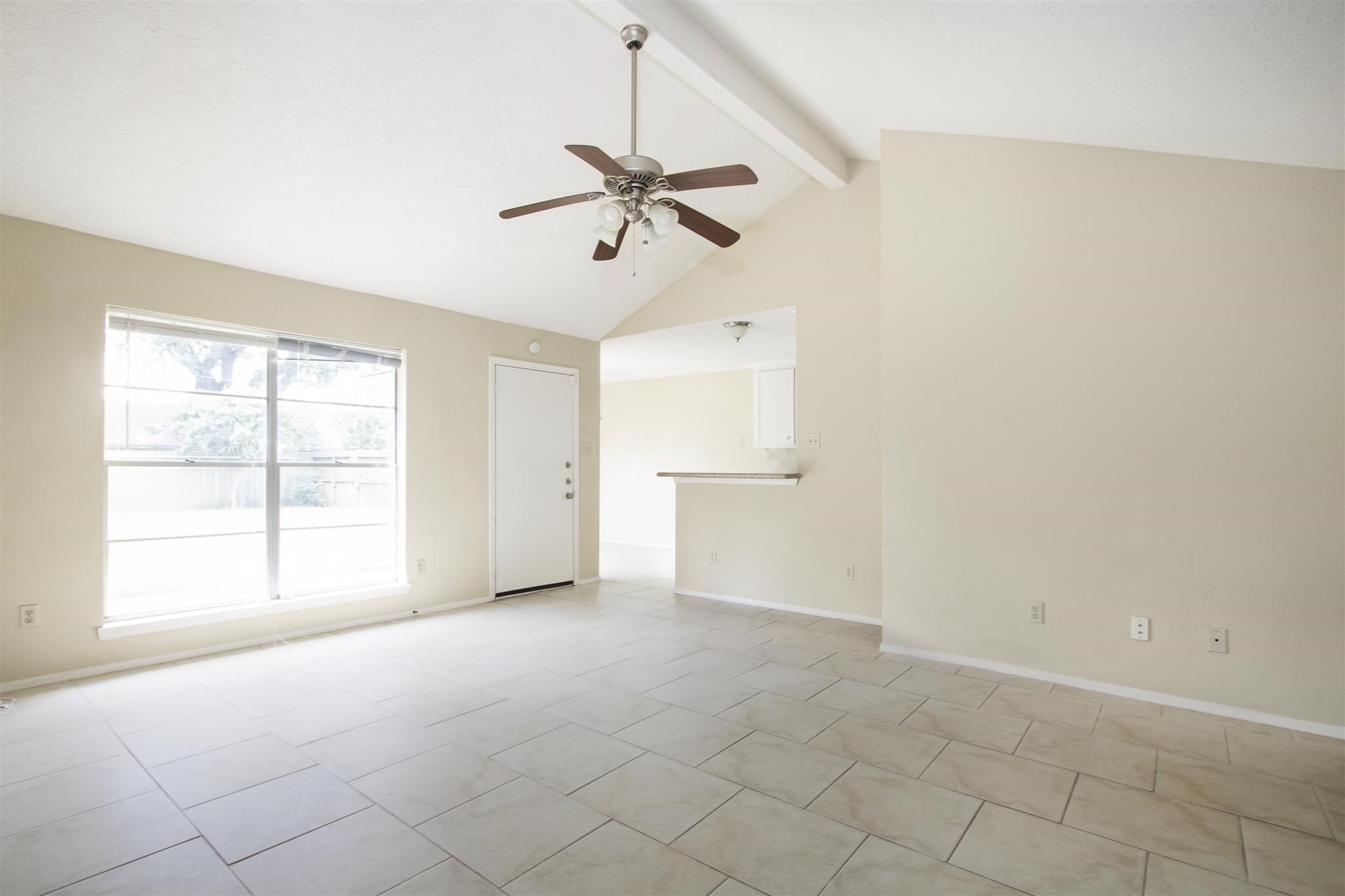 6019 Spellman Road Houston, TX 77096 - Photo 7 of 19 an empty room with windows and fan
