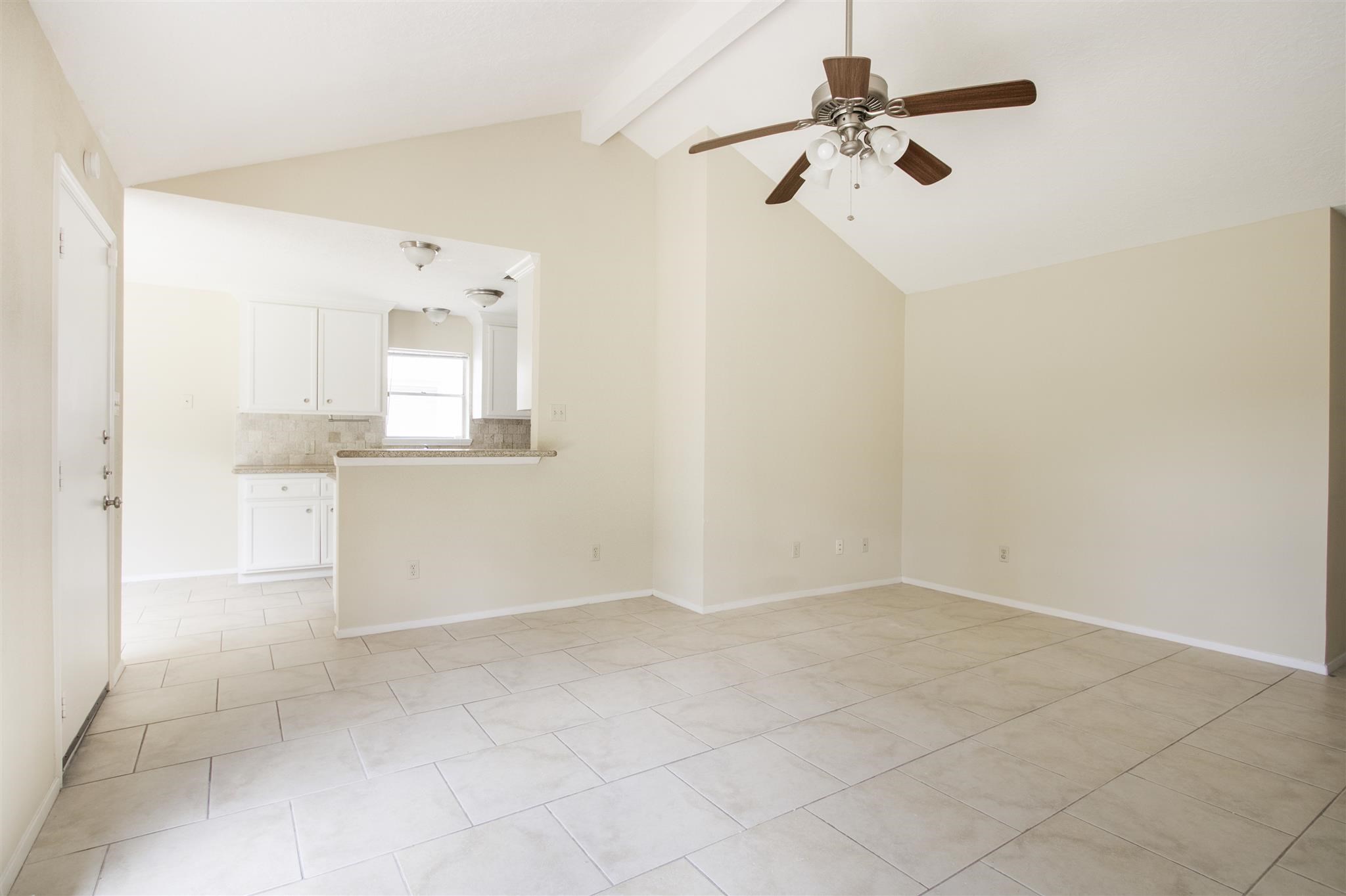 6019 Spellman Road Houston, TX 77096 - Photo 9 of 19 an empty room with a window and a chandelier fan