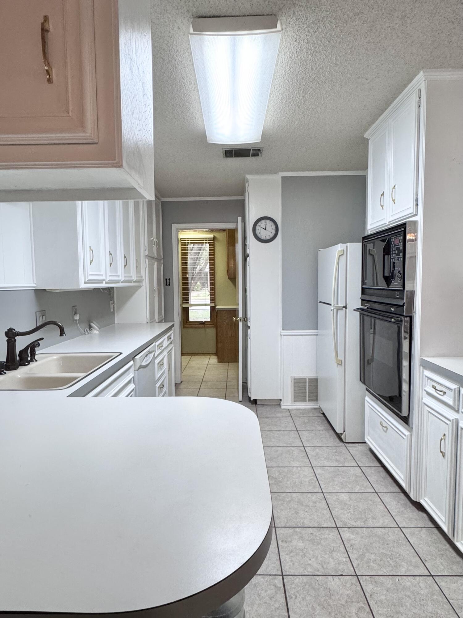 5617 87th Street Lubbock, TX 79424 - Photo 12 of 22 a kitchen with stainless steel appliances a refrigerator and a stove top oven