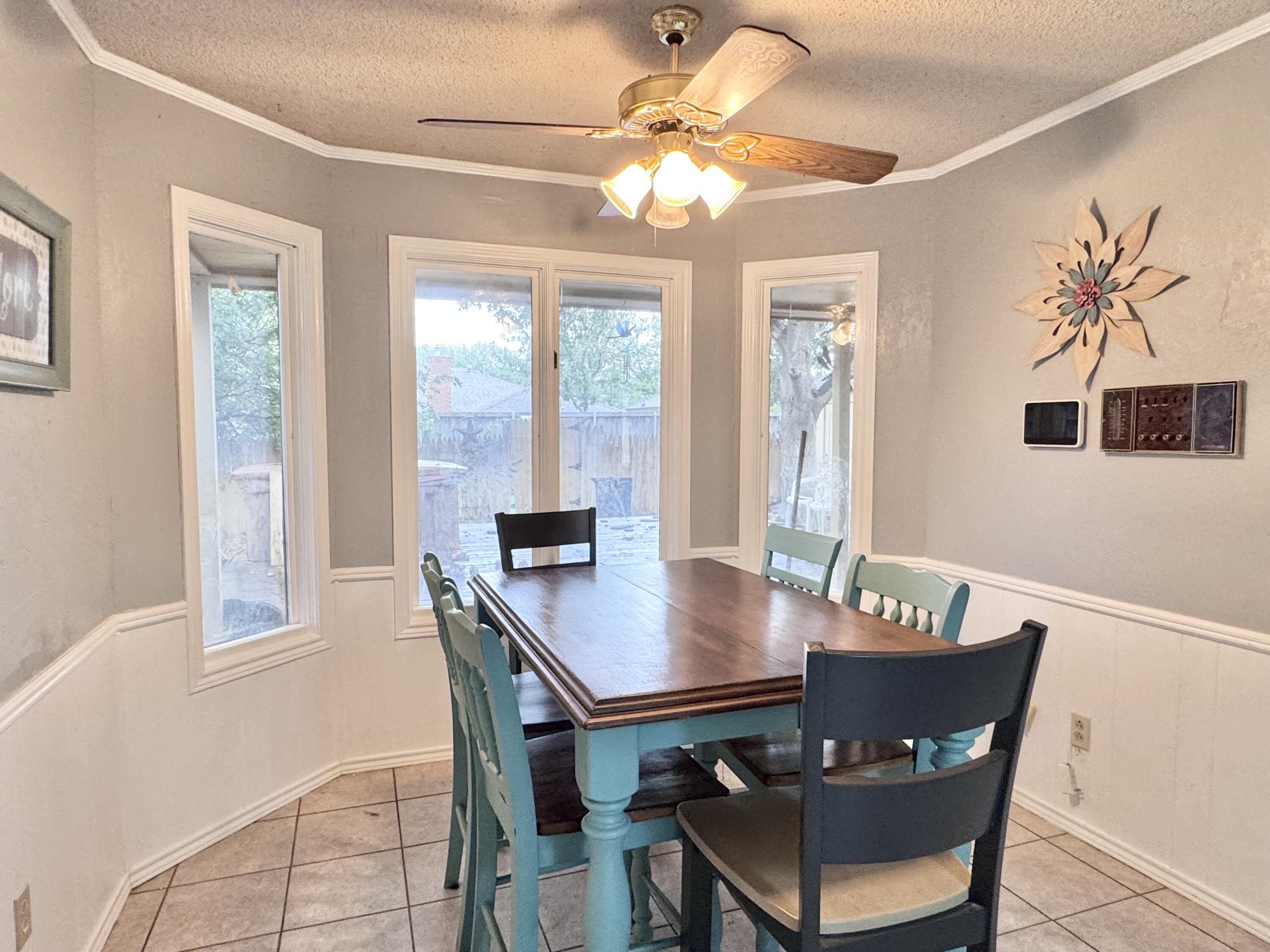 5617 87th Street Lubbock, TX 79424 - Photo 15 of 22 a view of a dining room with furniture window and wooden floor