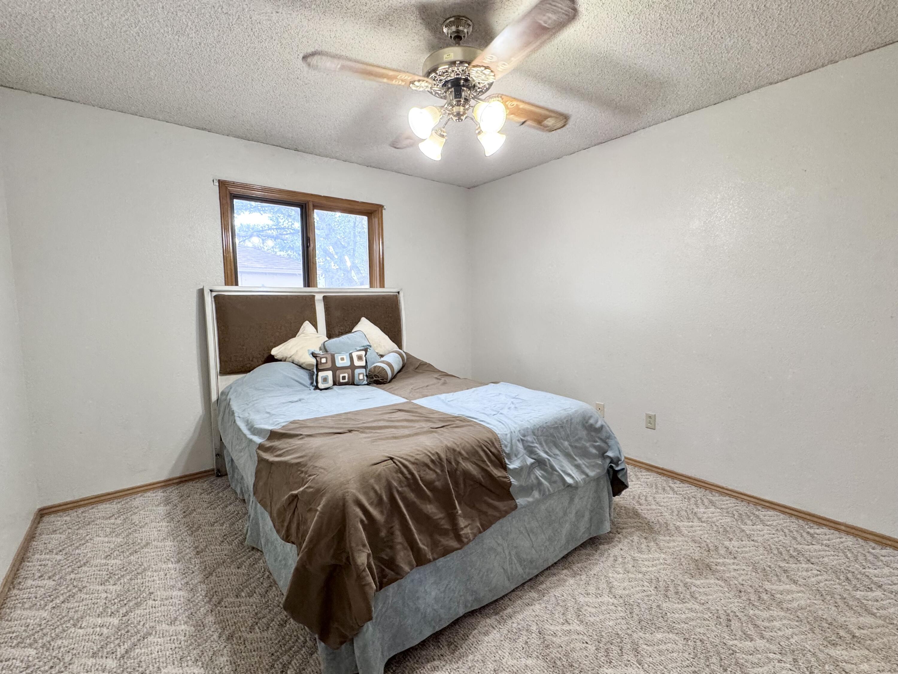 5617 87th Street Lubbock, TX 79424 - Photo 18 of 22 a bedroom with a bed and window