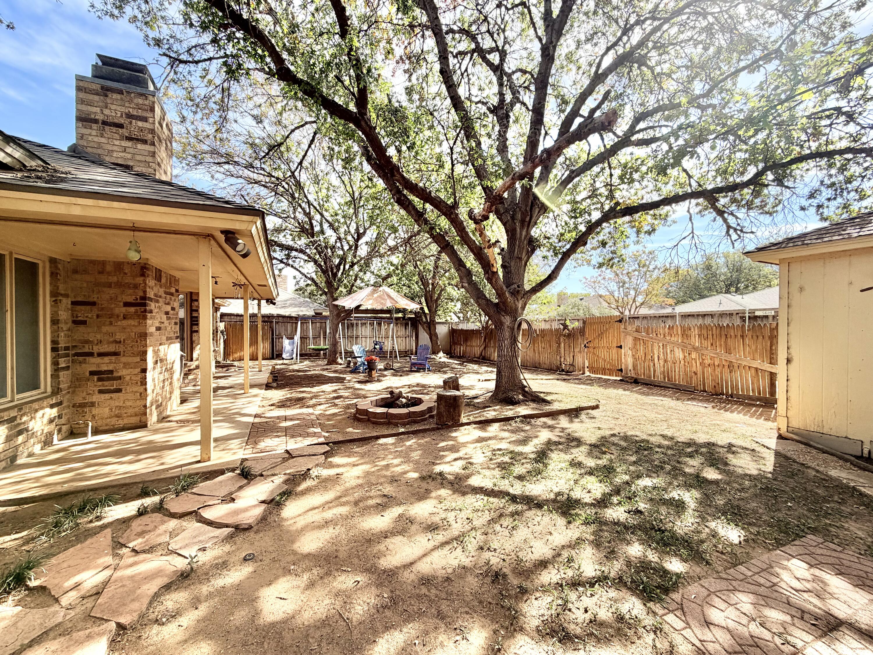 5617 87th Street Lubbock, TX 79424 - Photo 20 of 22 a view of a yard with a large tree
