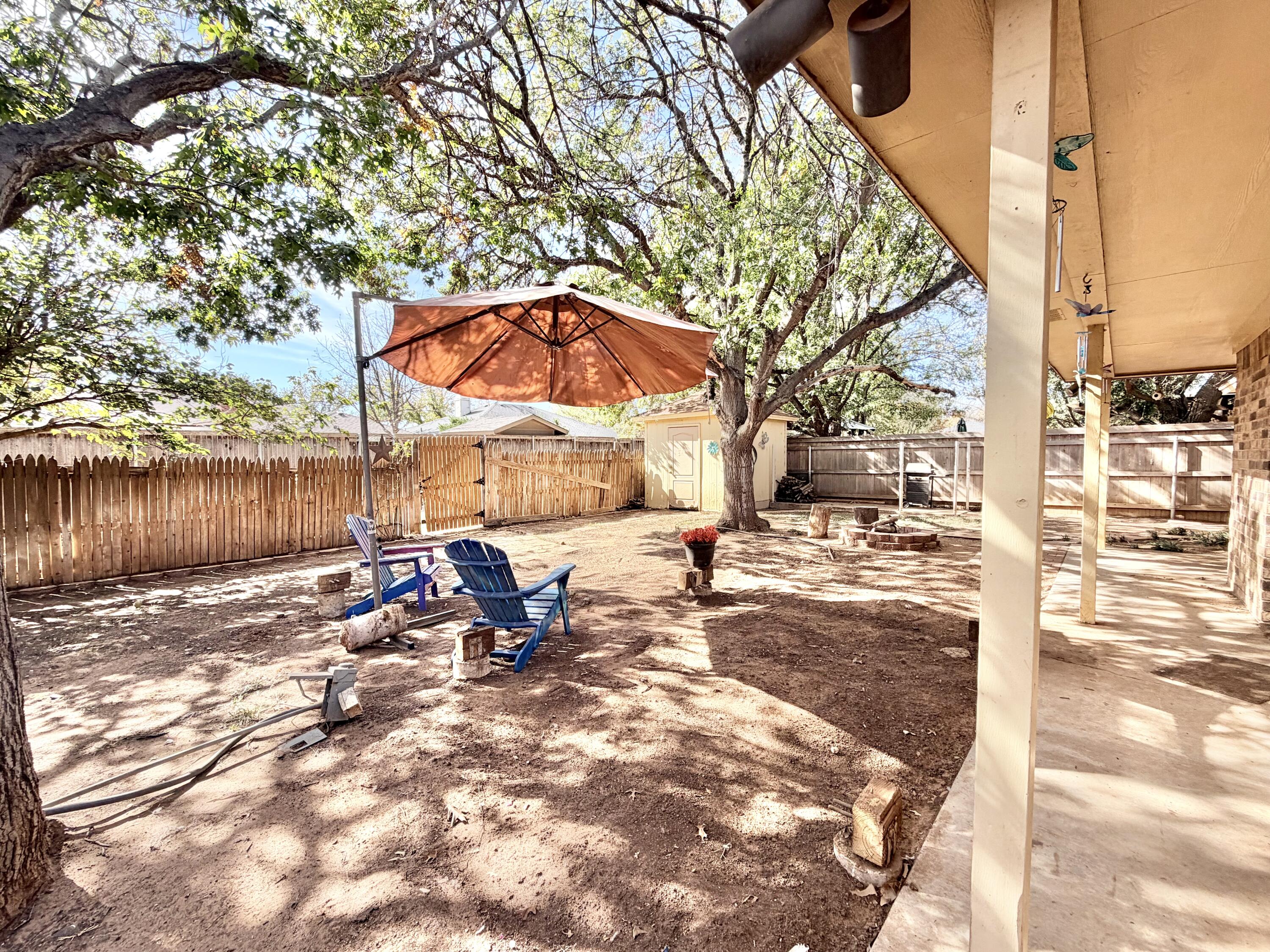 5617 87th Street Lubbock, TX 79424 - Photo 22 of 22 a view of a outdoor space with a patio and fire pit