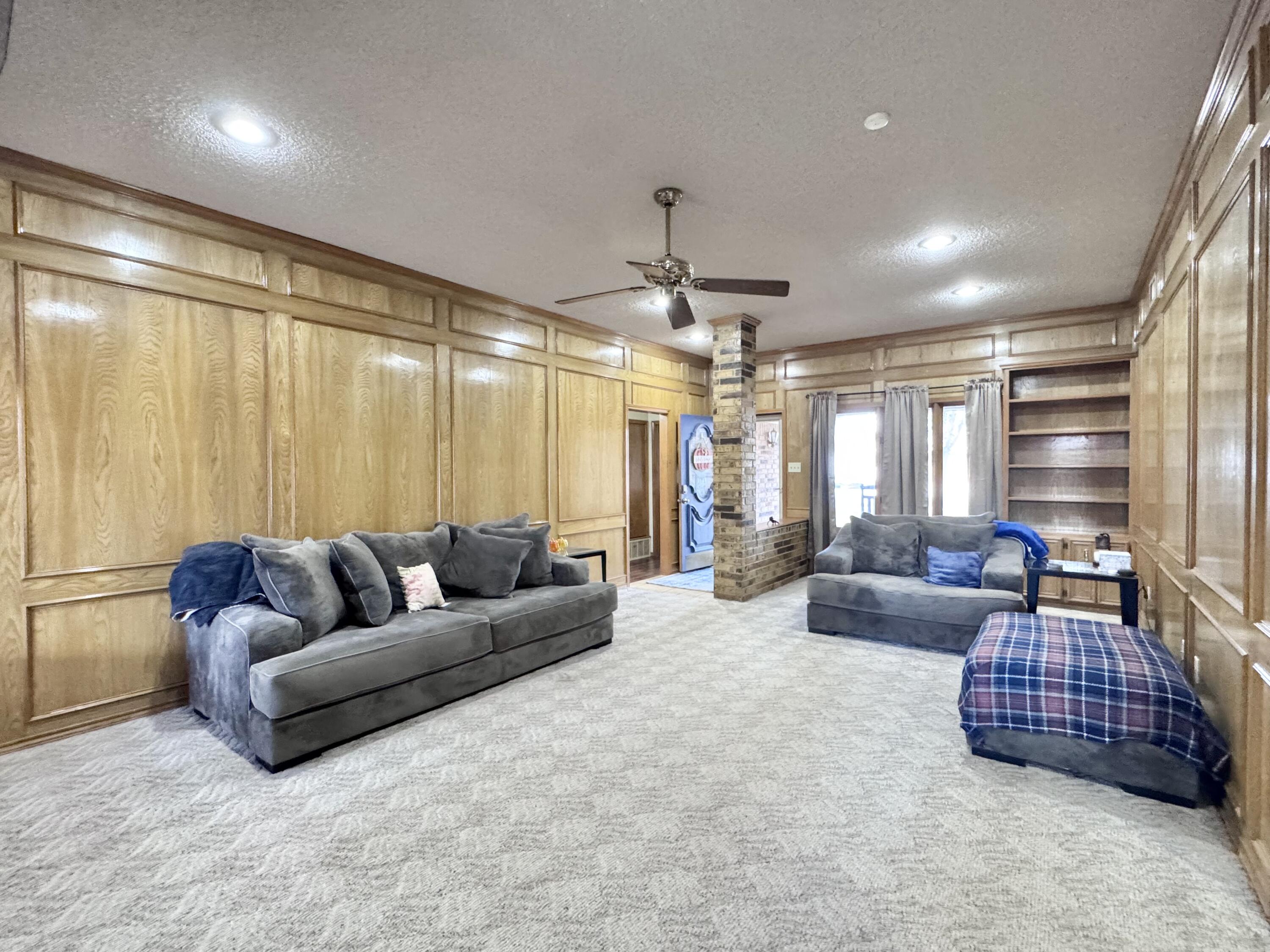 5617 87th Street Lubbock, TX 79424 - Photo 3 of 22 a living room with furniture ceiling fan and a window
