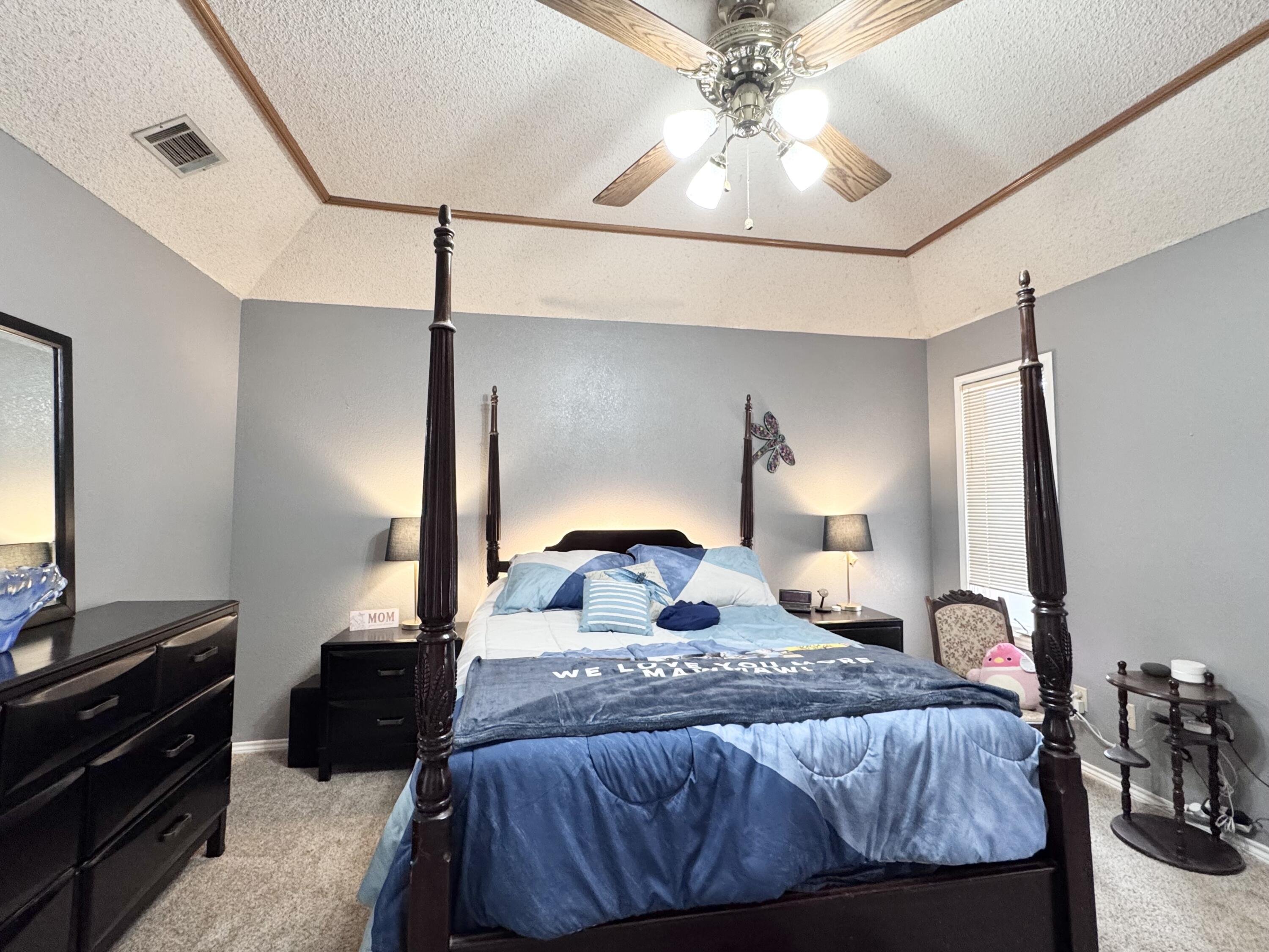 5617 87th Street Lubbock, TX 79424 - Photo 9 of 22 a bedroom with a bed and a mirror on the table