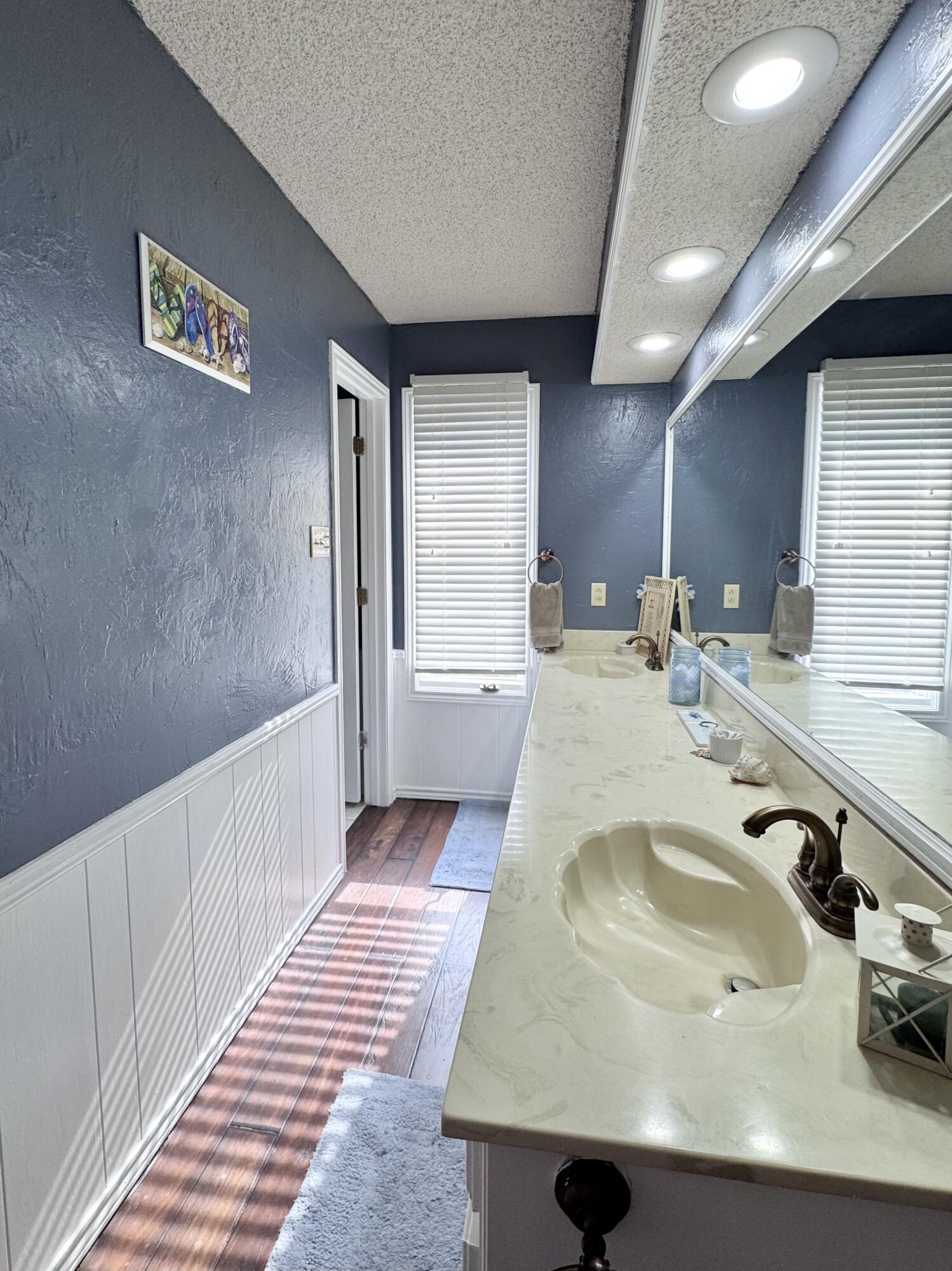 5617 87th Street Lubbock, TX 79424 - Photo 10 of 22 a bathroom with a sink and a mirror