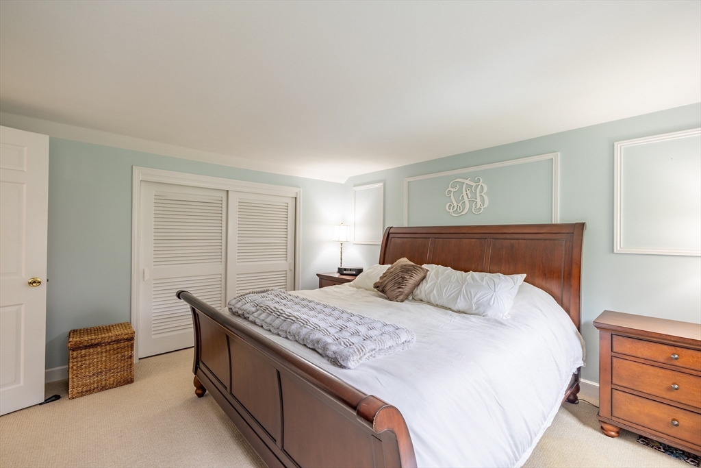 26 Roundtop Road Boxford, MA 01921 - Photo 28 of 42 a bedroom with a bed and a dresser