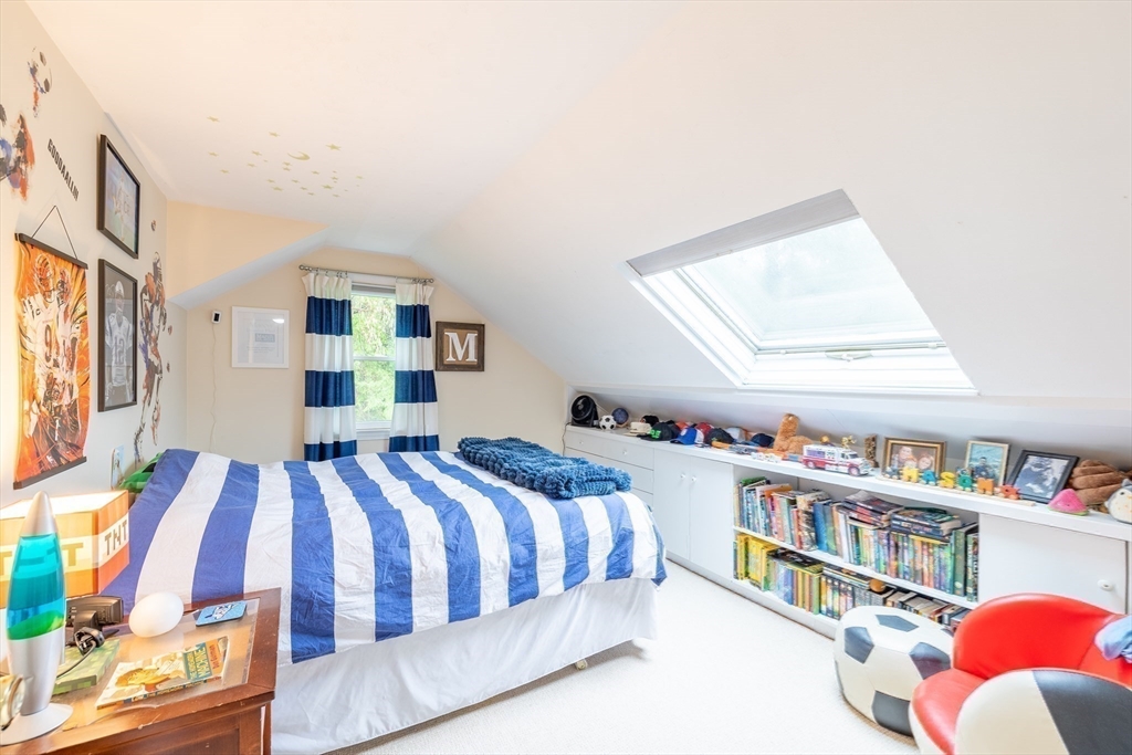 26 Roundtop Road Boxford, MA 01921 - Photo 29 of 42 a bedroom with a bed and a book shelf