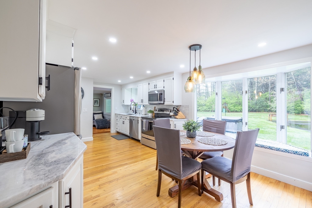 26 Roundtop Road Boxford, MA 01921 - Photo 7 of 42 a dining room with furniture a chandelier and wooden floor