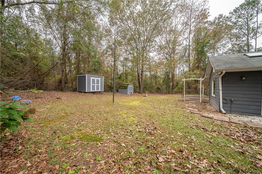 143 Lee Road 979 Phenix City, AL 36870 - Photo 10 of 37 View of yard featuring a storage shed