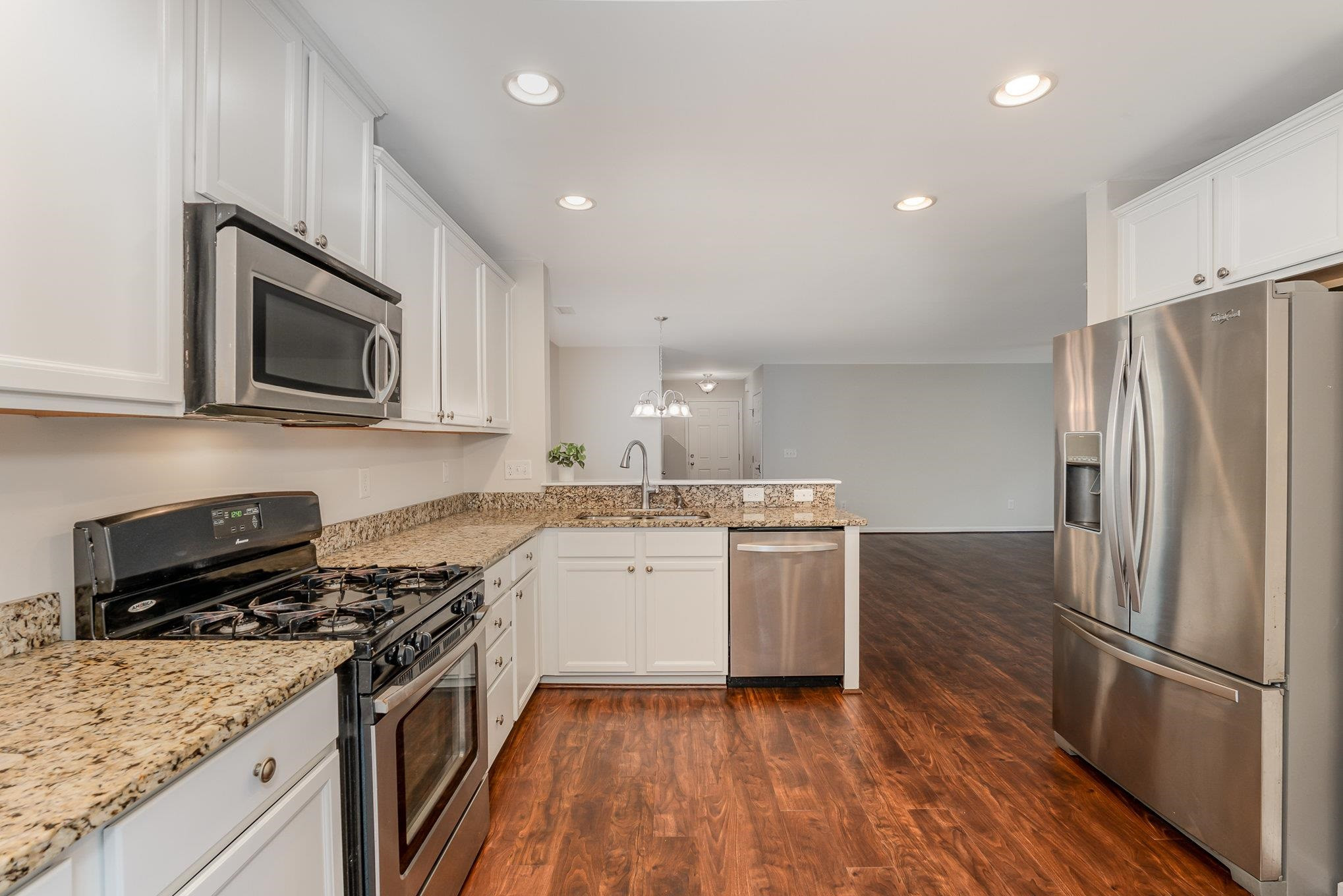 4364 Lyman Avenue Raleigh, NC 27616 - Photo 12 of 28 a kitchen with a sink stove and microwave