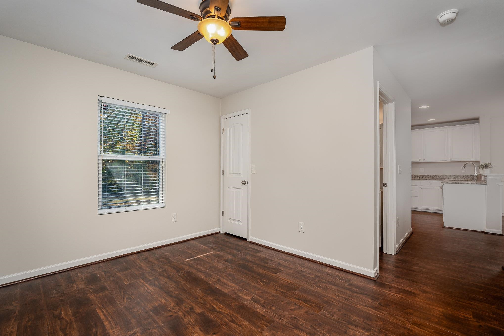 4364 Lyman Avenue Raleigh, NC 27616 - Photo 13 of 28 wooden floor in an empty room with a window