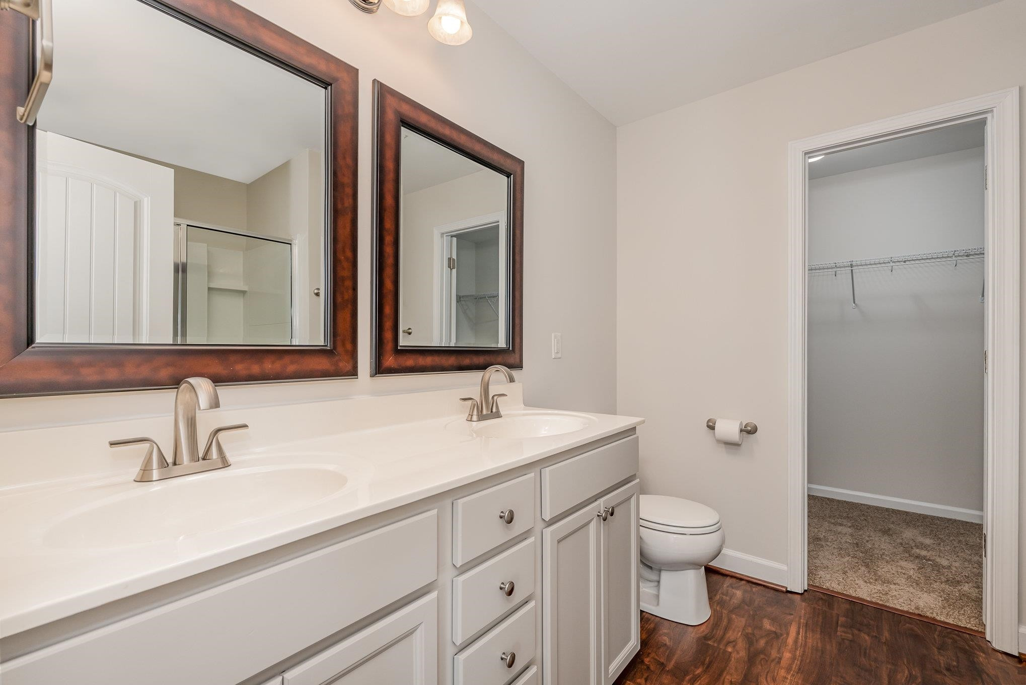 4364 Lyman Avenue Raleigh, NC 27616 - Photo 22 of 28 a bathroom with a sink a toilet and a mirror