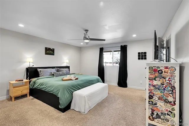 a bedroom with a large bed and a window