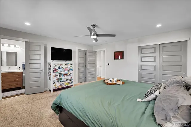 a bedroom with a bed and a television