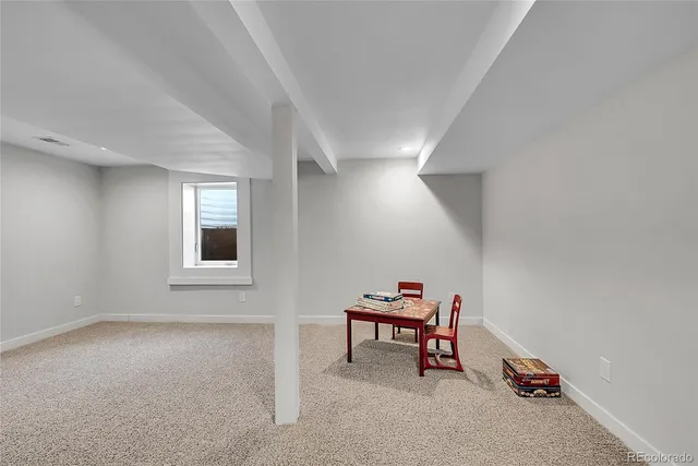 a living room with furniture a piano and a window
