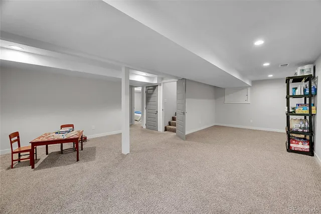a view of an empty room with shelves and wooden floor