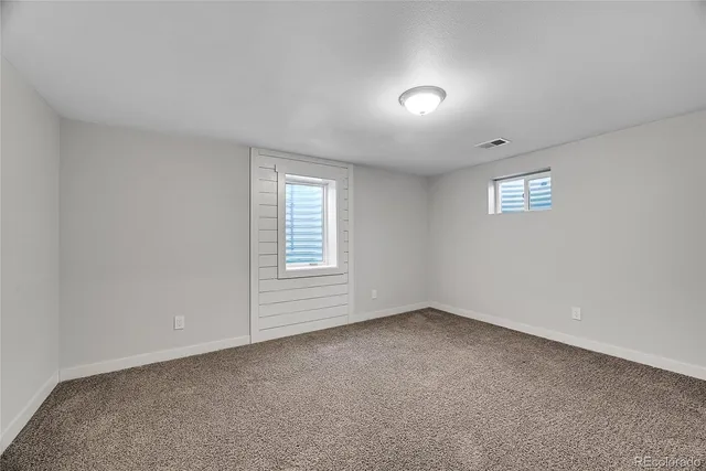 a view of an empty room and a window