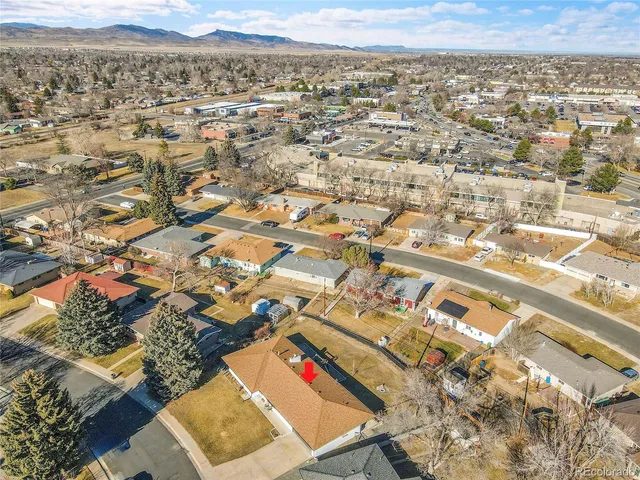 an aerial view of residential houses with city view