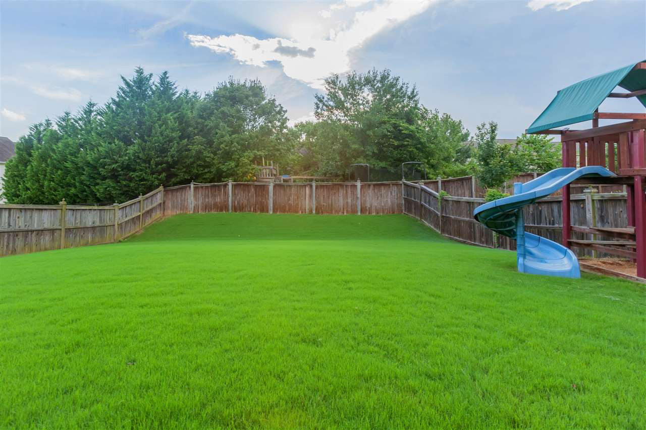 7613 Silver View Lane Raleigh, NC 27613 - Photo 21 of 25 Lush green grass and ample backyard space! Exterior Back