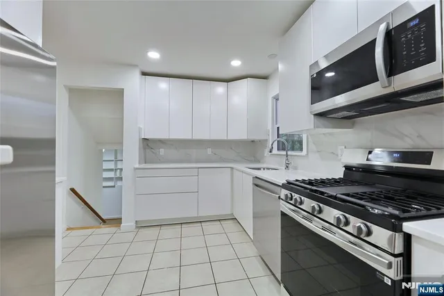 a kitchen with a stove a sink and a refrigerator