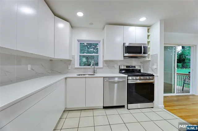a kitchen with a sink stove and microwave