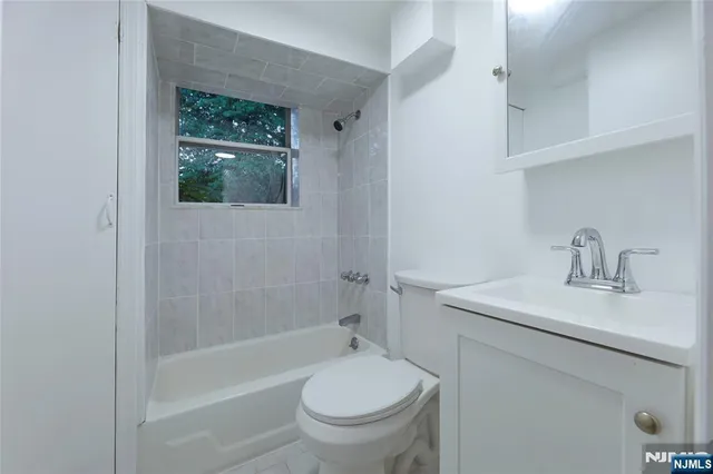 a bathroom with a sink a toilet and a bathtub