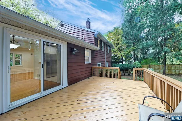 a view of a balcony with two chairs and a barbeque