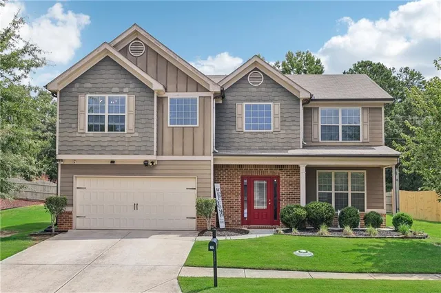 a front view of a house with a yard