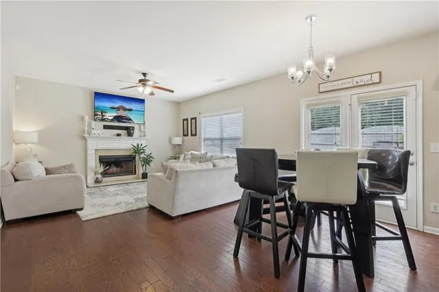 a view of a dining room with furniture a chandelier and wooden floor