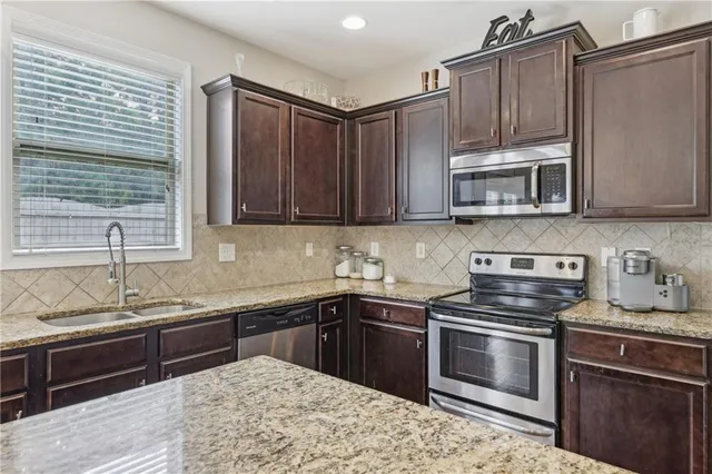 a kitchen with a sink stove and microwave