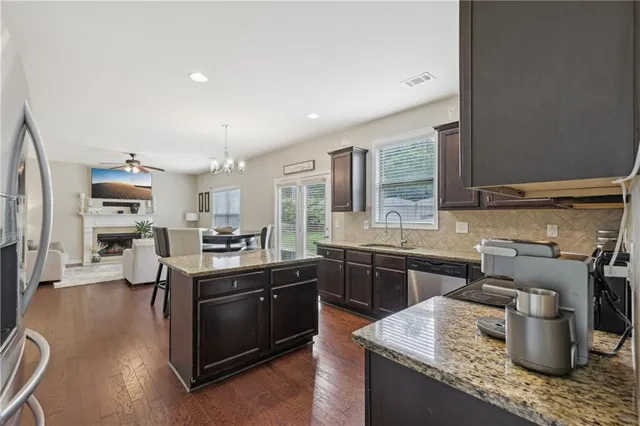a kitchen with a sink dishwasher stove and cabinets